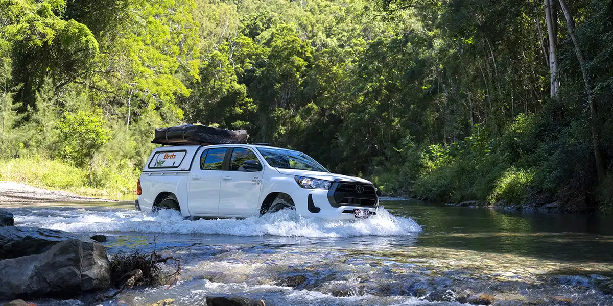 4WD Safari Camper crossing a creek